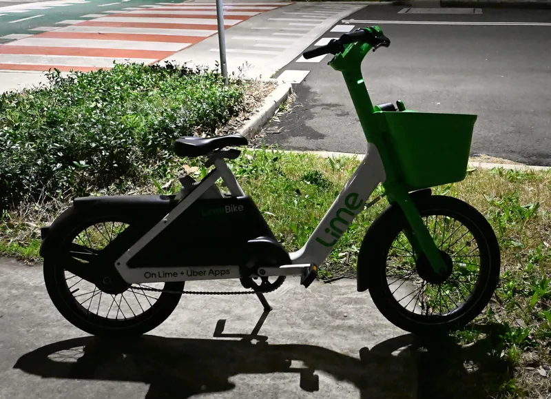 A Lime e-bike — green fork, green basket and the Lime wordmark on the frame.