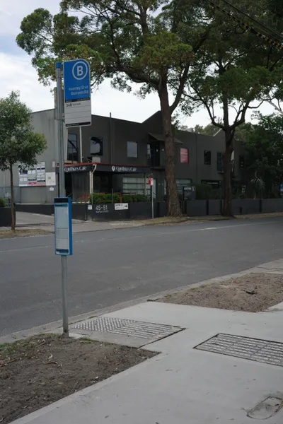 A bus stop flag and its timetable case: the routes that stop here, their destinations and the stop number (here, route 348 to Wolli Creek).