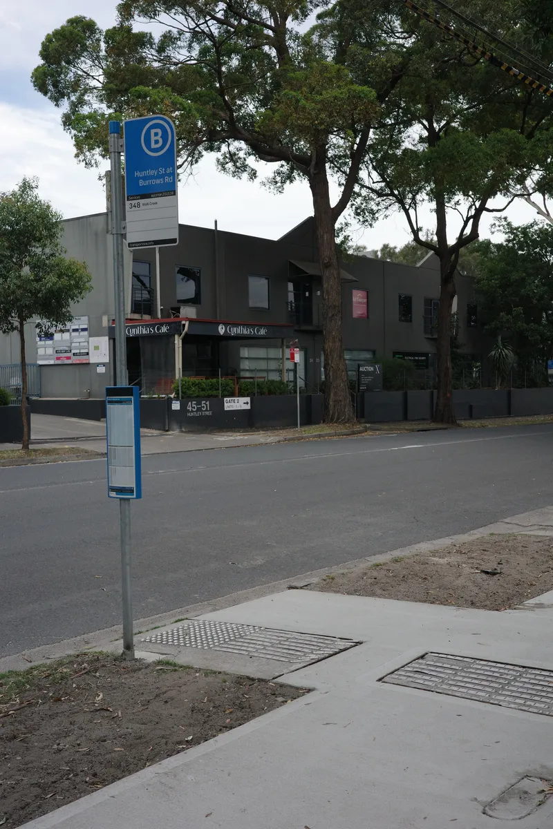 A bus stop flag and its timetable case: the routes that stop here, their destinations and the stop number (here, route 348 to Wolli Creek).