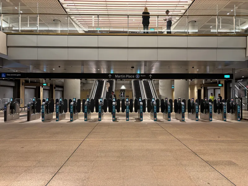 Fare gates on the metro side of Martin Place station — tap a card or phone on the reader at each gate