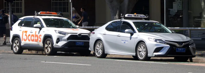NSW taxis: a roof sign and a plate starting with T. These are the only cars you can hail on the street.