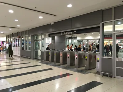 Station fare gates: a green arrow means the gate is set your way, a red X means it is not. Tap the reader on top.
