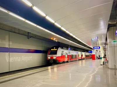 The platform at Vienna Airport station, with 'Vienna Airport' lettering on the wall.