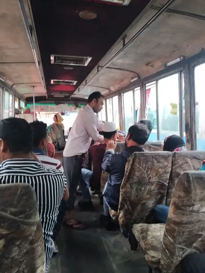 The conductor works his way down the aisle — you pay him in cash at your seat, not the driver