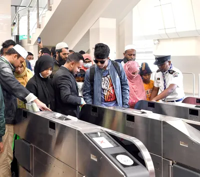 Fare gates at Uttara North Station — touch the card to enter