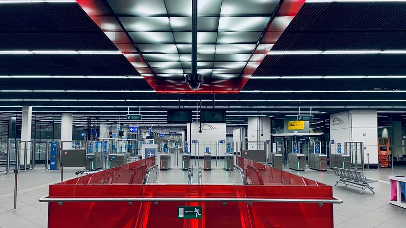 The gates at the airport station. The overhead sign — scan your train ticket — is in Dutch, French, German and English.