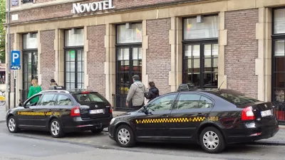 Taxis waiting at a rank. Their number plates carry the TX series reserved for taxis.