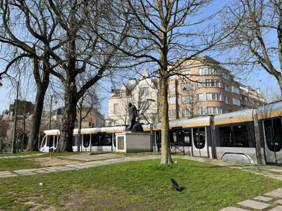 A low-floor T4000 tram; older high-floor cars run alongside them.