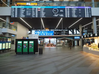 Departure boards at Pasila: the commuter panel runs line letter (A, P, I, E, K), minutes to departure, track number, then destination — and destinations alternate between Finnish and Swedish, so the same station shows up as both Leppävaara and Alberga.