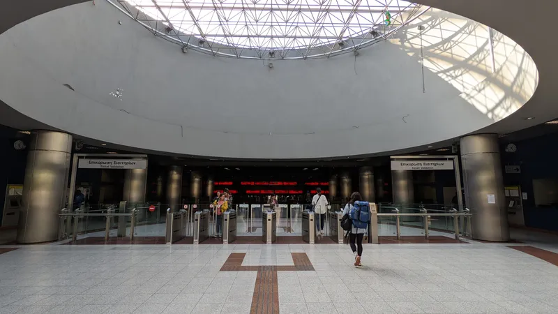 Fare gates under the "Ticket Validation" sign — tap the reader on top of the gate, then walk through an aisle showing a green arrow