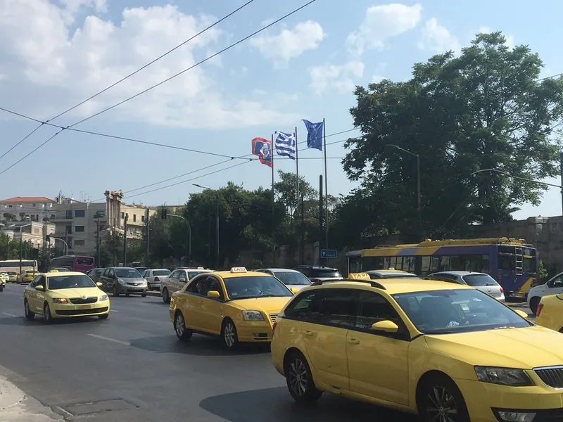 Athens' licensed taxis are yellow, with a ΤΑΞΙ/TAXI sign on the roof