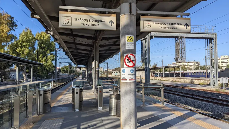 The fare gates at the entrance to the suburban railway platforms — tap the reader on top of the gate, under separate signs for "Ticket issue" and "Ticket validation"