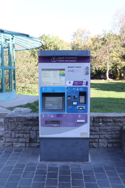 A BKK ticket machine, headed "Jegyek és bérletek / Tickets and passes". You pick the ticket on the screen at left and pay at right with coins, notes or a card.