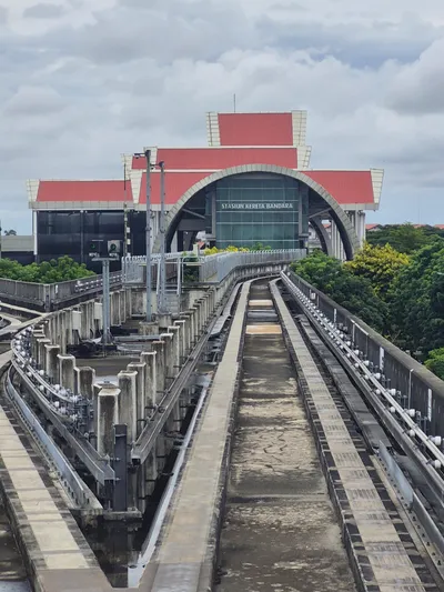 The airport rail station, signed STASIUN KERETA BANDARA across the glass
