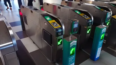 MRT ticket gates — tap your card at a gate showing a green light