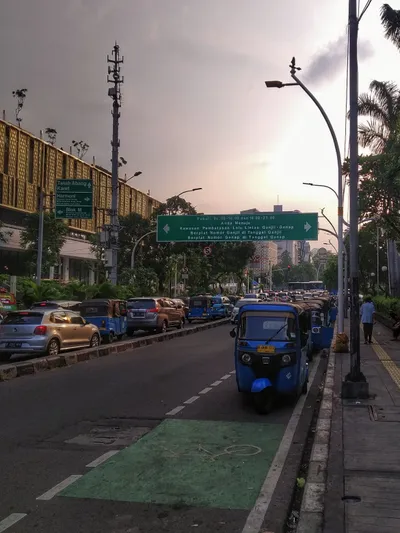 Bajaj queued at the kerb waiting for fares; turn one down and the next is right behind