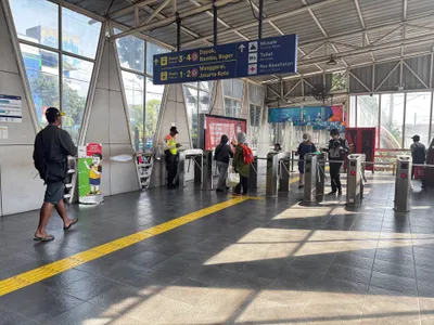 The gates at Pasar Minggu: tap in, then read the overhead sign for platform and direction