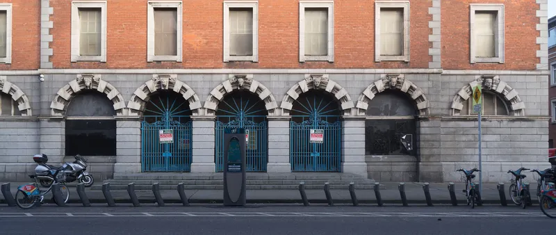 A dublinbikes station. The column in the middle is the terminal - day tickets are bought here or in the app - and the docking points run along the kerb.
