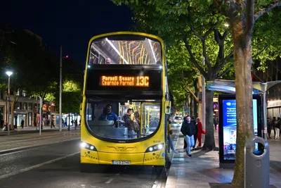 You board at the front door, where the driver sits. The fare machine stands beside the cab, and that is where you say your destination and pay.
