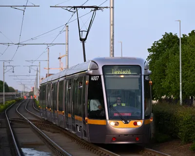 A Red Line tram. The destination blind reads 'Tamhlacht', the Irish name for Tallaght.
