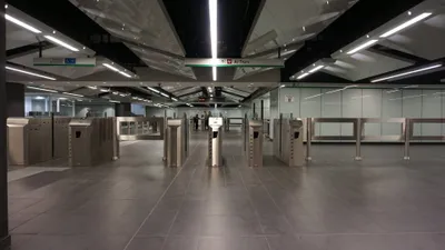 Fare gates at Mirti station on Line C — the round yellow pad on top is the card reader