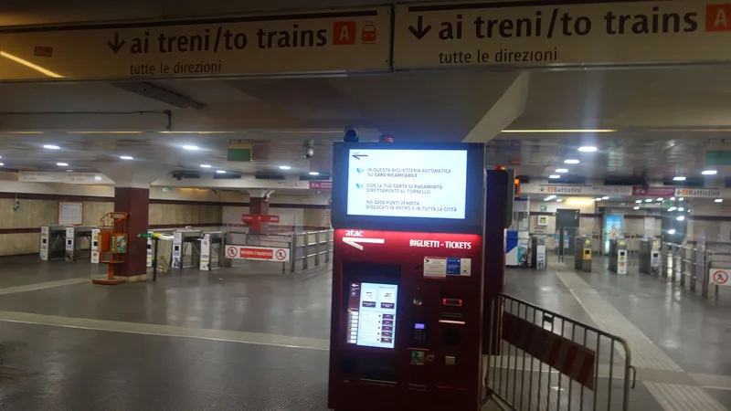 An ATAC ticket machine; a "Tap & Go" sign hangs above the fare gates behind it