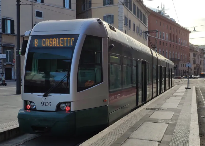 An ATAC tram at a stop — the platform is a low raised strip in the roadway