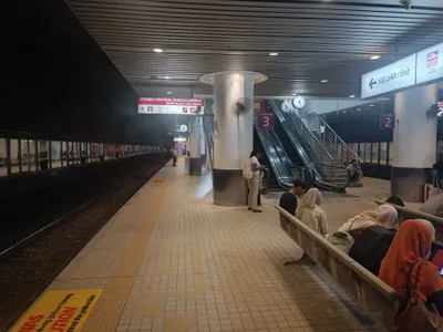 The ERL platform at KL Sentral — the overhead sign carries the pink KLIA ekspres mark next to the way out (KELUAR / Exit)