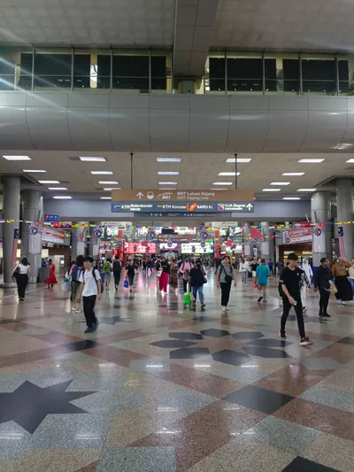 The KL Sentral concourse — one board points to KLIA Ekspres, KTM Komuter, KTM Intercity, Rapid KL and the MRT