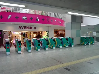 Fare gates at KLCC LRT station — tap the card on the reader to pass