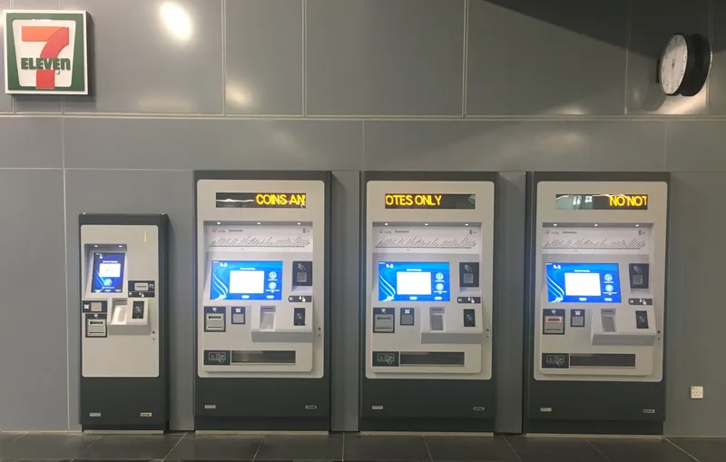 Station ticket machines — buy a single-journey token here; Touch 'n Go comes from the counter or a convenience store
