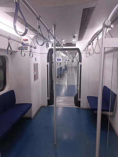 Inside a KTM Komuter Class 92 — longitudinal seats and standing room, commuter-style