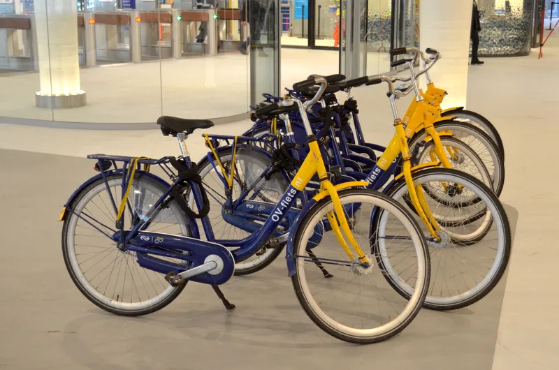 The station-hire OV-fiets: navy frame, yellow front fork. It is not a free-floating street bike, and renting one needs a personal OV-chipkaart.