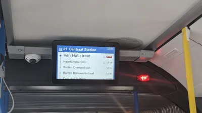 The screen inside the bus: line number and destination at the top, then the next stop and the arrival times for the ones after it.