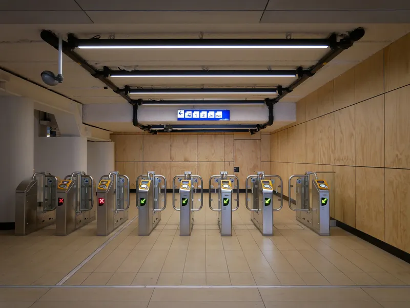 Ticket gates at Amsterdam Centraal - tap your card on the yellow reader. A green tick means that gate is open for use.