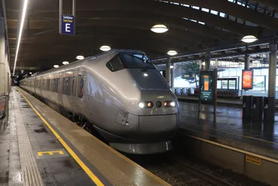 The Flytoget airport express - silver with an orange stripe.
