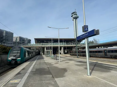 The platforms at the airport station: green Vy on the left, silver Flytoget on the right. Same station, two entirely separate fare systems.