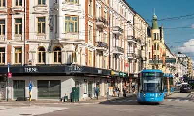 Oslo's trams are light blue, with the line number and destination shown on the front.