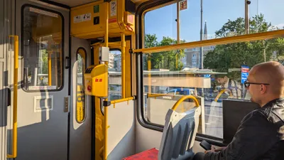 The validator beside a tram door — paper tickets go into the red slot on the front.