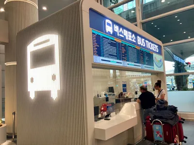 The bus ticket counter at Incheon T1. Routes and times are listed under the 버스매표소 / BUS TICKETS sign.