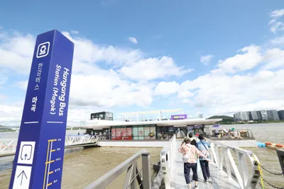 Magok pier. Cross the ramp past the navy marker post to reach the floating terminal; the post lists the pier names down its face.