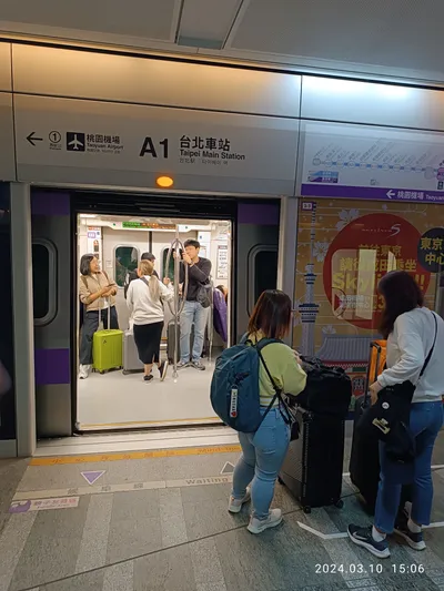 Platform at A1 Taipei Main — the sign gives the station and the airport direction, the floor marks where to line up