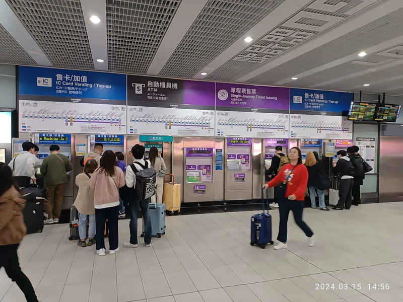 Ticket machines at Terminal 1 station — "IC Card Vending / Top-up" for stored-value cards, "Single-Journey Ticket" for a one-way token