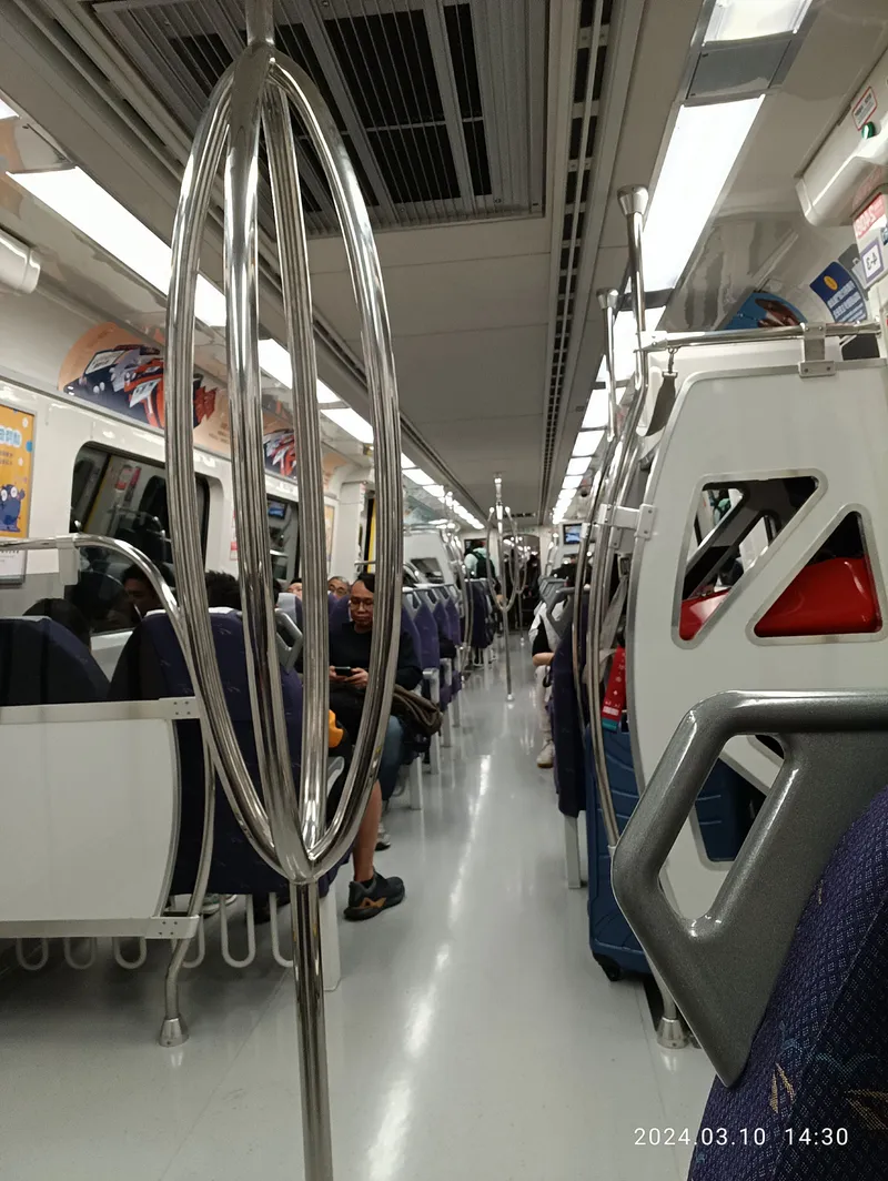 Inside the train — there's room for a full-size suitcase beside the seats