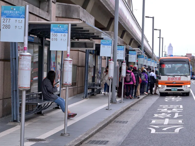 Bus stop at Jiantan — overhead panels give the route number and destination, the cylinder holds the route map