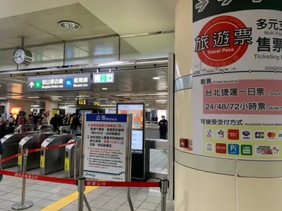 Fare gates at Ximen Station — hold your card over the reader before the flaps