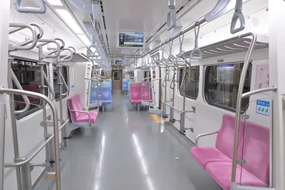 Inside a TRA local train (EMU900) — the service you can ride straight in on an EasyCard, with paired seats and plenty of straps