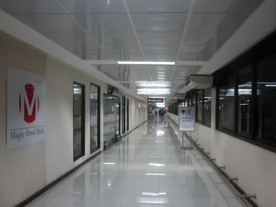 The walkway between Don Mueang station and the airport terminal, signed “Terminal”