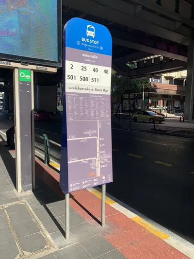 A bus stop sign: the stop name, then the route numbers that call here