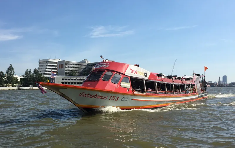 The orange flag at the stern of an express boat — the flag colour is the line and the fare